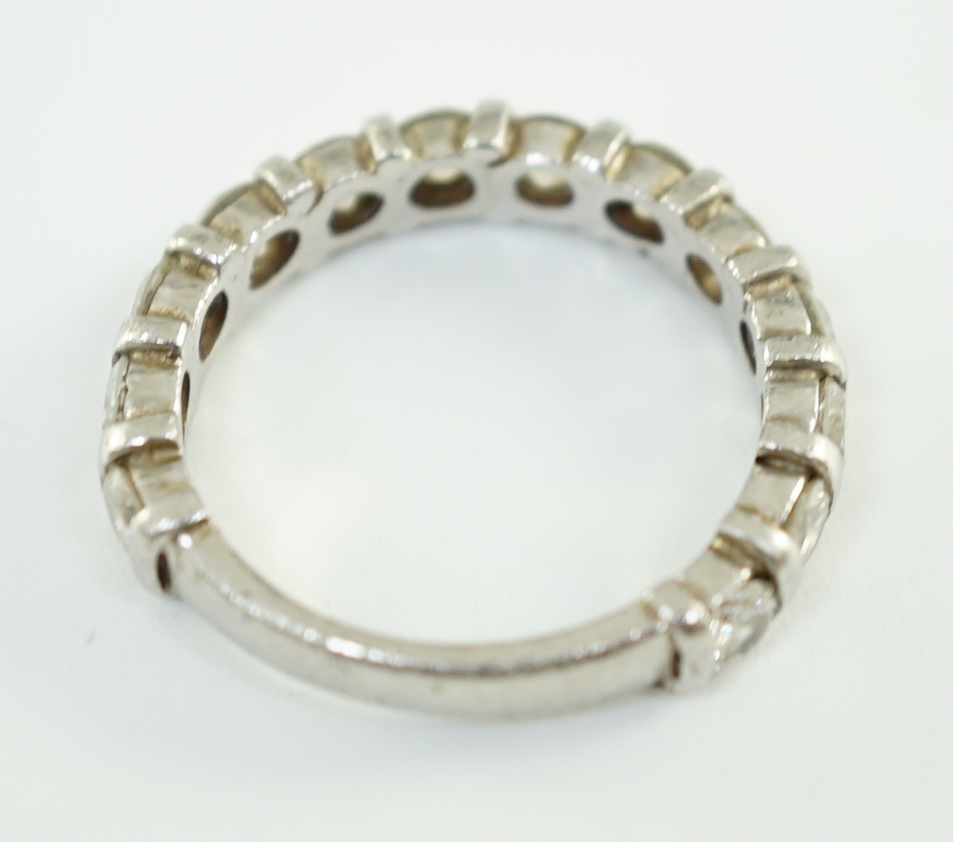 An 18ct white gold and thirteen stone round brilliant cut diamond set three quarter eternity ring